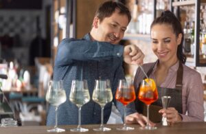 manager teaches new bar tender