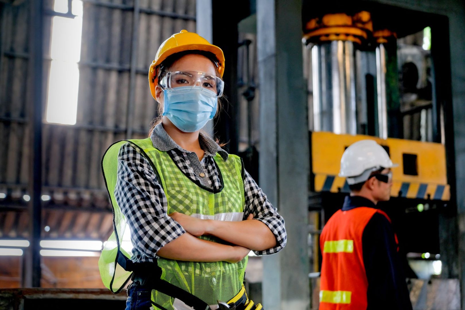 Woman in a manufacturing factory with a face mask